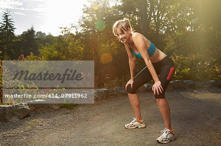 Exhausted female runner taking a break in park