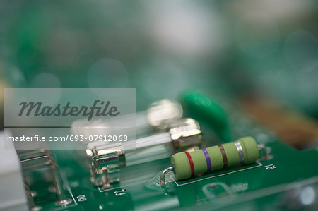 Close-up of fuse and resistor on circuit board