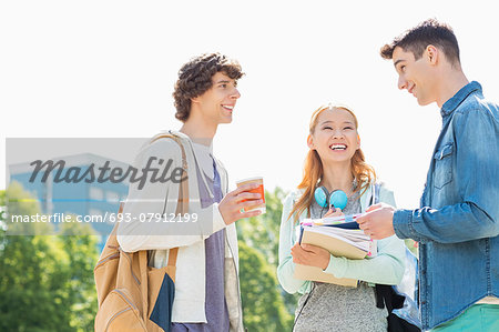 Happy university students conversing at campus