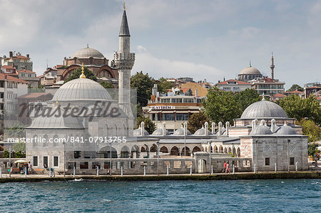 Couple walking past the Semsi Pasa Mosque, seen from the Bosphorus Strait, Uskudar, Istanbul, Turkey, Europe