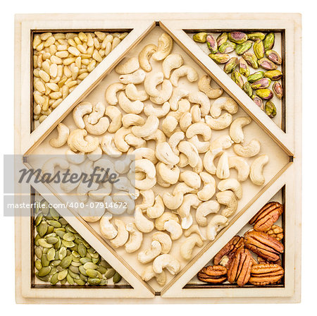 cashew and other nuts (pecan,  almond, pine, pistachio, peanut) in a geometrical wood tray