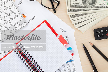 Office table with pc, supplies and money cash. View from above with notepad for copy space