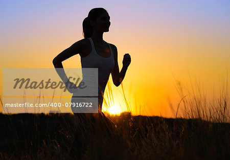 Young Beautiful Woman Running on the Mountain Trail in the Morning. Active Lifestyle