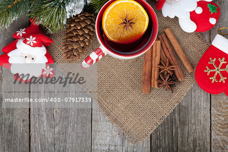 Christmas mulled wine with fir tree and decor on wooden table