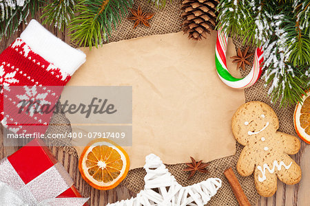 Christmas food and decor with snow fir tree background with paper for copy space