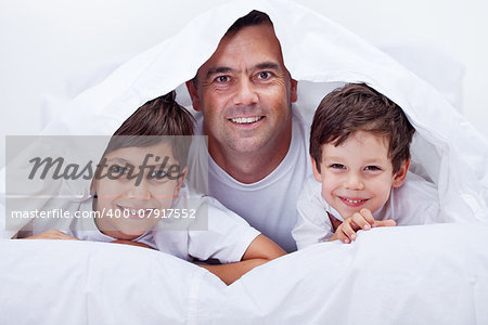 Father and his sons spending some lazy time together having fun