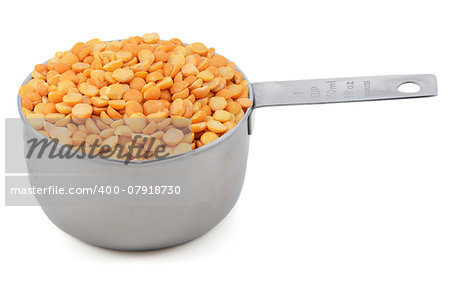 Yellow split peas in an American cup measure, isolated on a white background