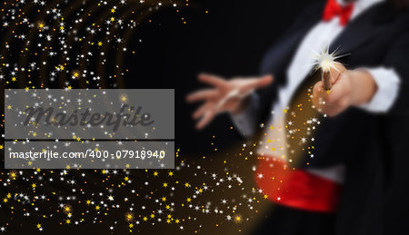Magician hands with magic wand conjuring sparkling stars stream - copy space
