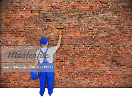 house painter from behind paints brick wall