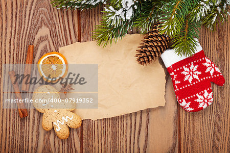 Christmas food and decor with snow fir tree background with paper for copy space