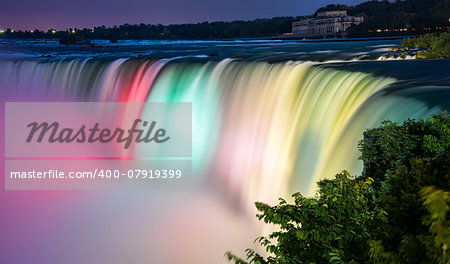Niagara falls lit by colorful lights of many colors