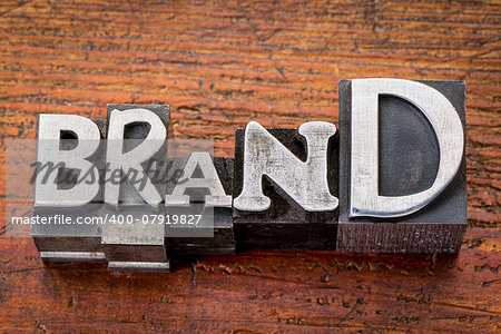 brand word in vintage metal type printing blocks over grunge wood, mixed fonts in style and size