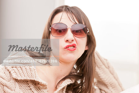 woman with sunglasses making funny faces (perplexed)