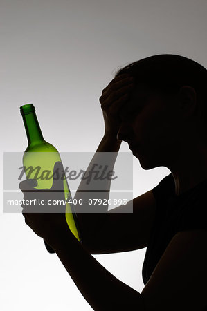 Alcoholic woman's silhouette with a wine bottle