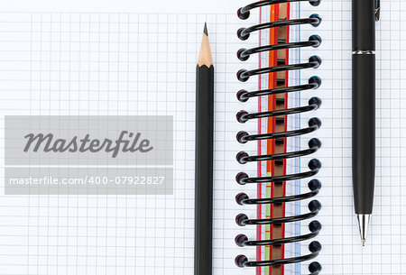 Blank notepad with pen and pencil. Closeup with copy space