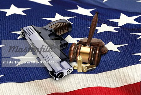 Hand Gun with Gavel and Bullets on American Flag