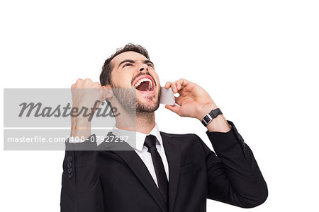 Cheering businessman in suit on the phone on white background