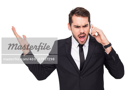 Angry businessman gesturing on the phone on white background