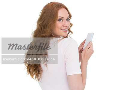 Pretty redhead sending text message on white background