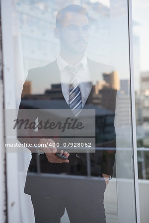 Businessman looking out the window in his office