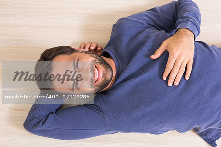 Happy man lying on floor at home