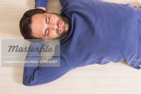 Sleeping man lying on floor at home in the living room