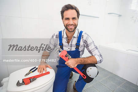 Plumber smiling at the camera in the bathroom