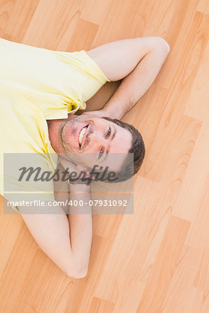 A man lying on floor at home in the living room