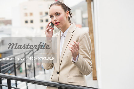 Young businesswoman on the phone outside in the city