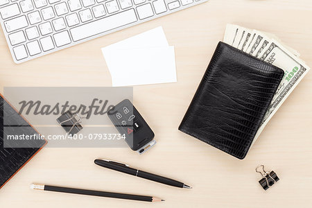 Office table with pc, supplies, business cards and money cash. View from above