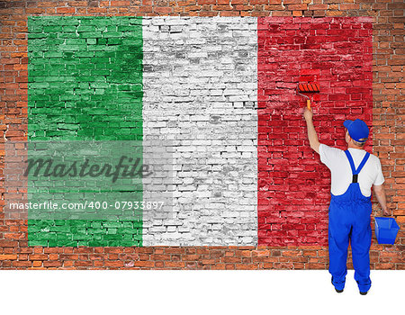 House painter paints flag of Italy on old brick wall