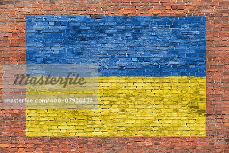 Flag of Ukraine painted over aged brick wall
