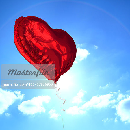Red heart balloon against cloudy sky with sunshine