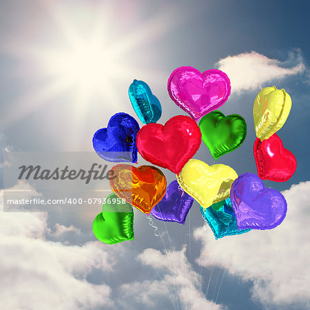 Heart balloons against sky