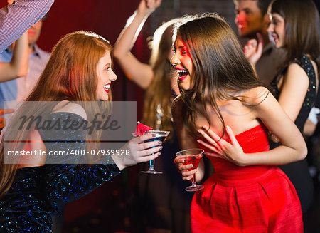 Happy friends having fun together at the nightclub