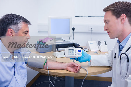 Doctor talking to his patient about his blood pressure at the hospital