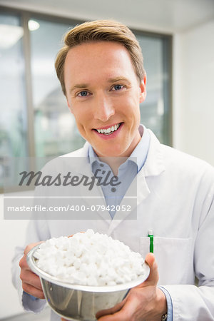 Pharmacist showing bowl of pills at the hospital pharmacy