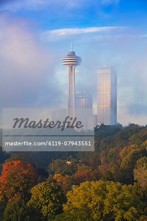 Mist from Horseshoe Falls swirling in front of Skylon Tower at dawn, Niagara Falls, Niagara, Ontario, Canada, North America