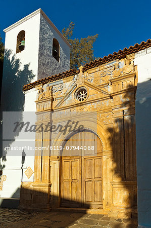 Bell tower and ornate doorway of the late 17th century Church of Nuestra Senora de la Regla, Pajara, Fuerteventura, Canary Islands, Spain, Atlantic, Europe