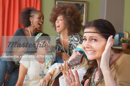 Lady cringing as group of friends sing and play music