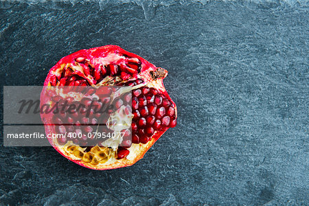 Closeup on pomegranate on stone substrate