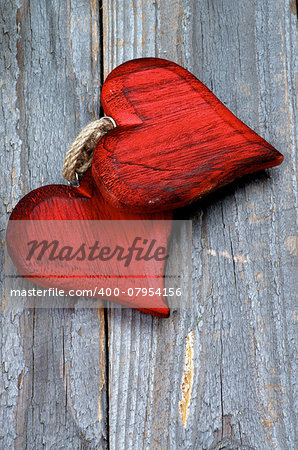 Two Wooden Red Hearts isolated on Rustic Wooden background