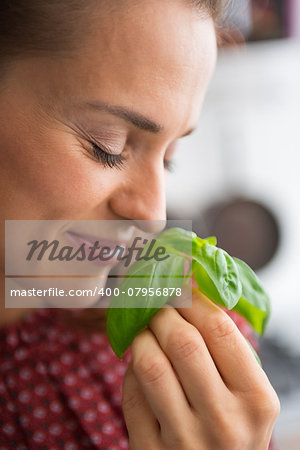 Young woman enjoying fresh basil