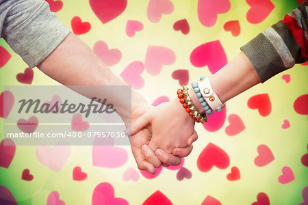 Students holding hands against valentines heart design