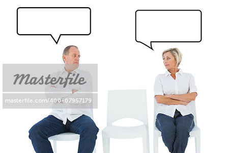 Upset couple not talking to each other after fight against speech bubble