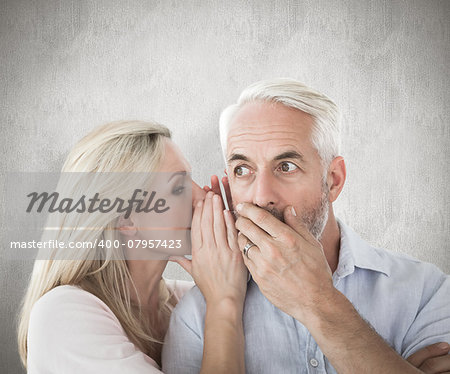 Woman whispering a secret to husband against weathered surface