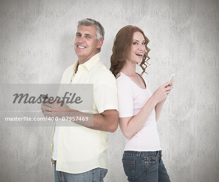 Casual couple sending text messages against white background