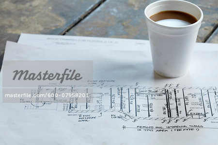 Home Renovation Still Life with Blueprint and Styrofoam Coffee Cup