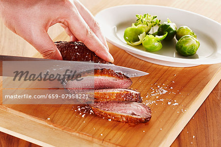 Roasted duck breast being sliced Roasted duck breast being sliced