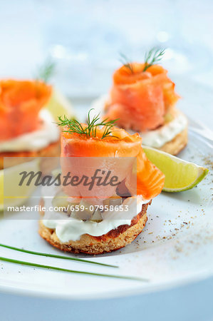 Blinis topped with smoked salmon, cream and gherkins